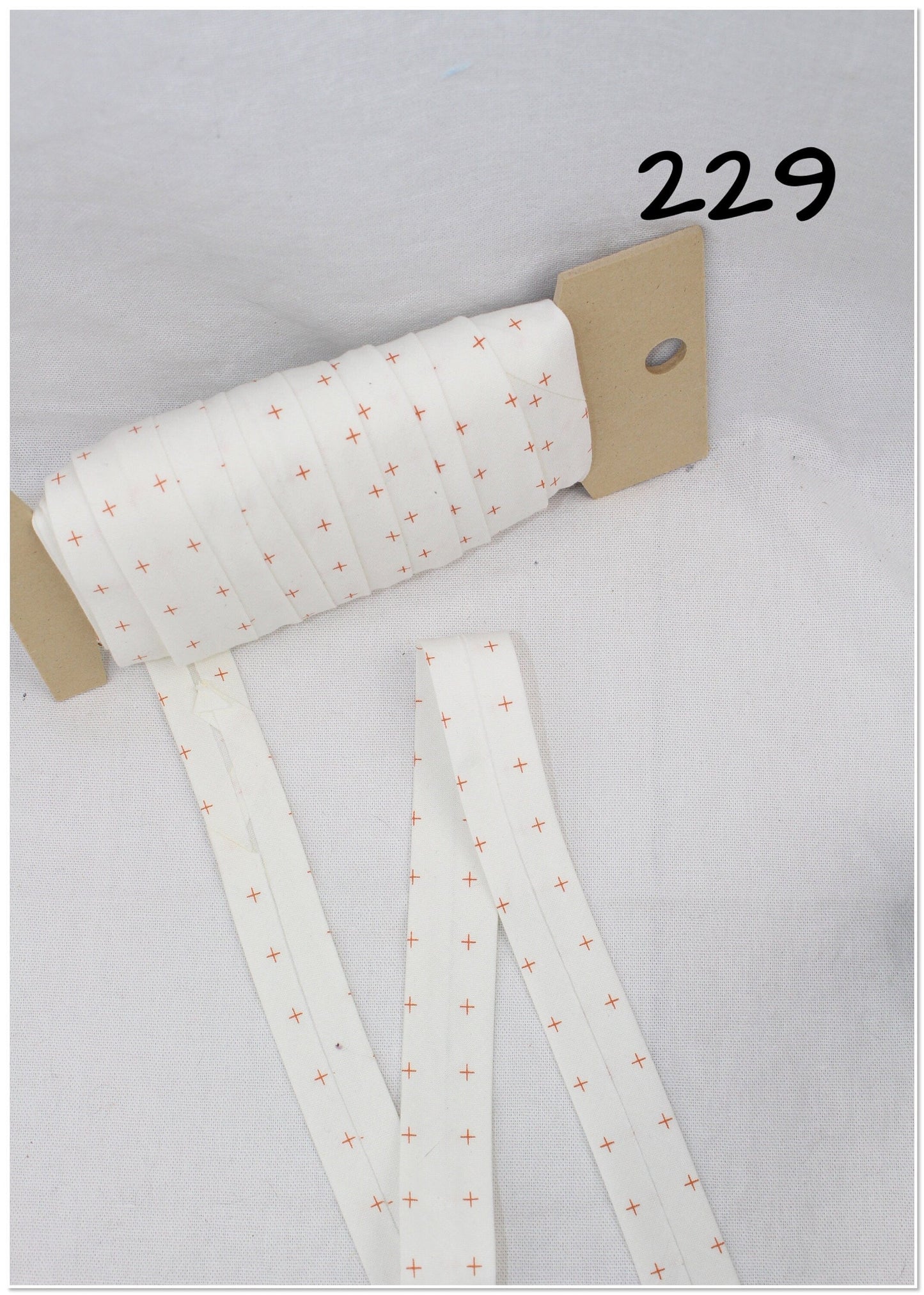 Bias Binding (Tape) 25mm, Cotton, Single Fold, white and crosses. Fusible iron on available.