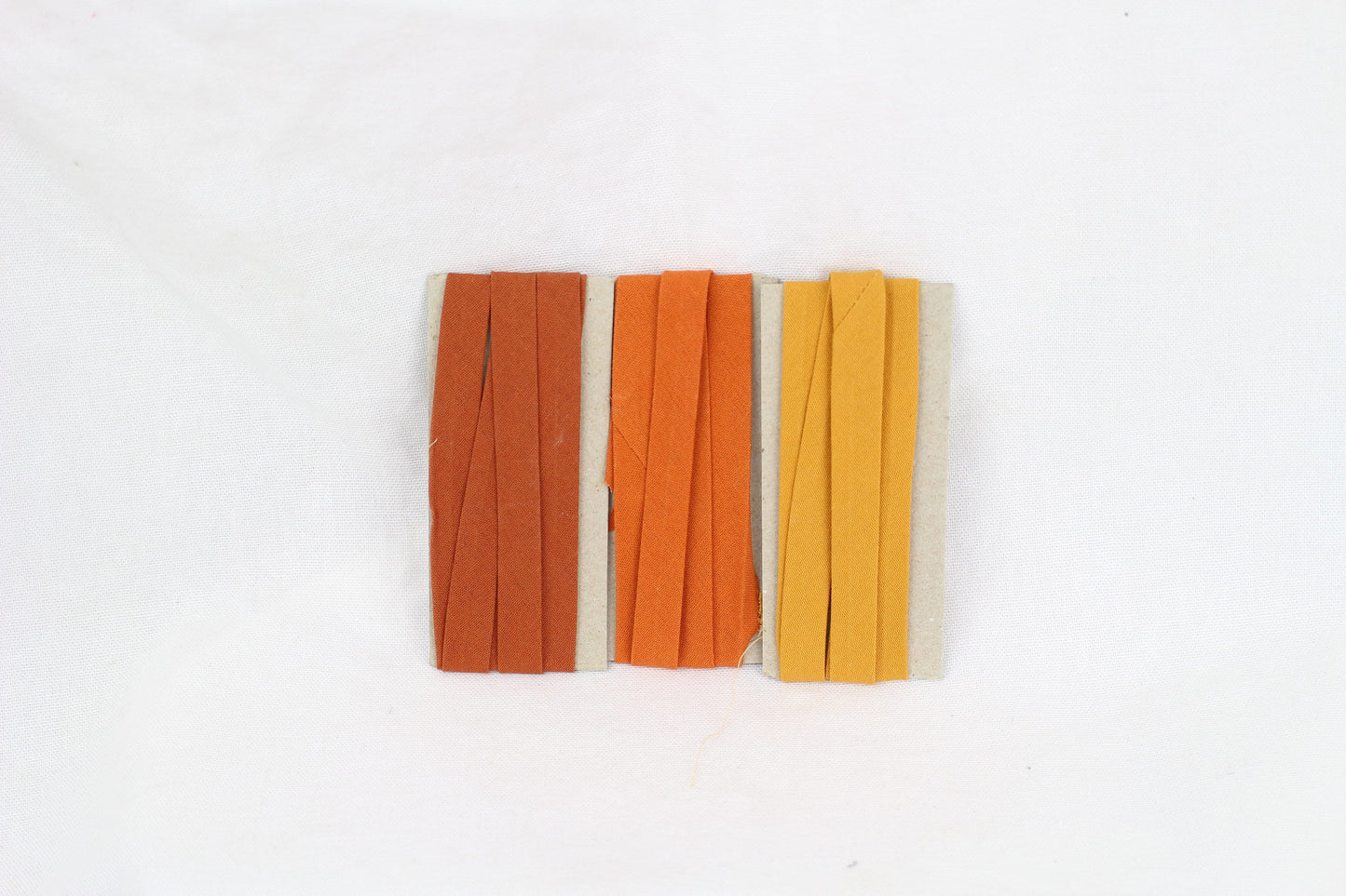 Bias Binding (tape) 25mm, single fold. Pumpkin, butterscotch, sienna. Fusible iron on.