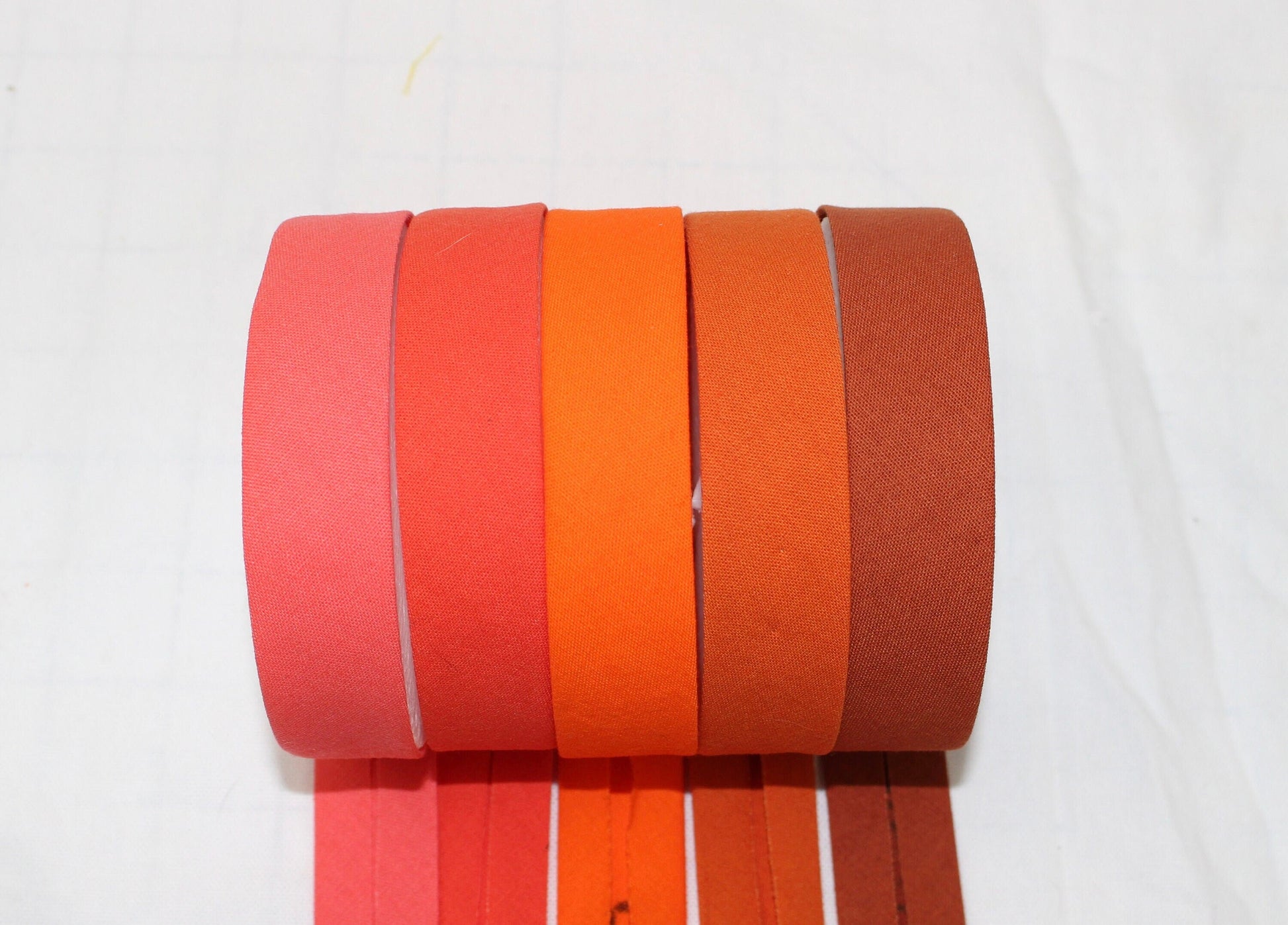 Bias Binding (tape) 25mm or 12mm, single fold, 100% Cotton. coral, orange, pumpkin, sienna. Fusible iron on available.