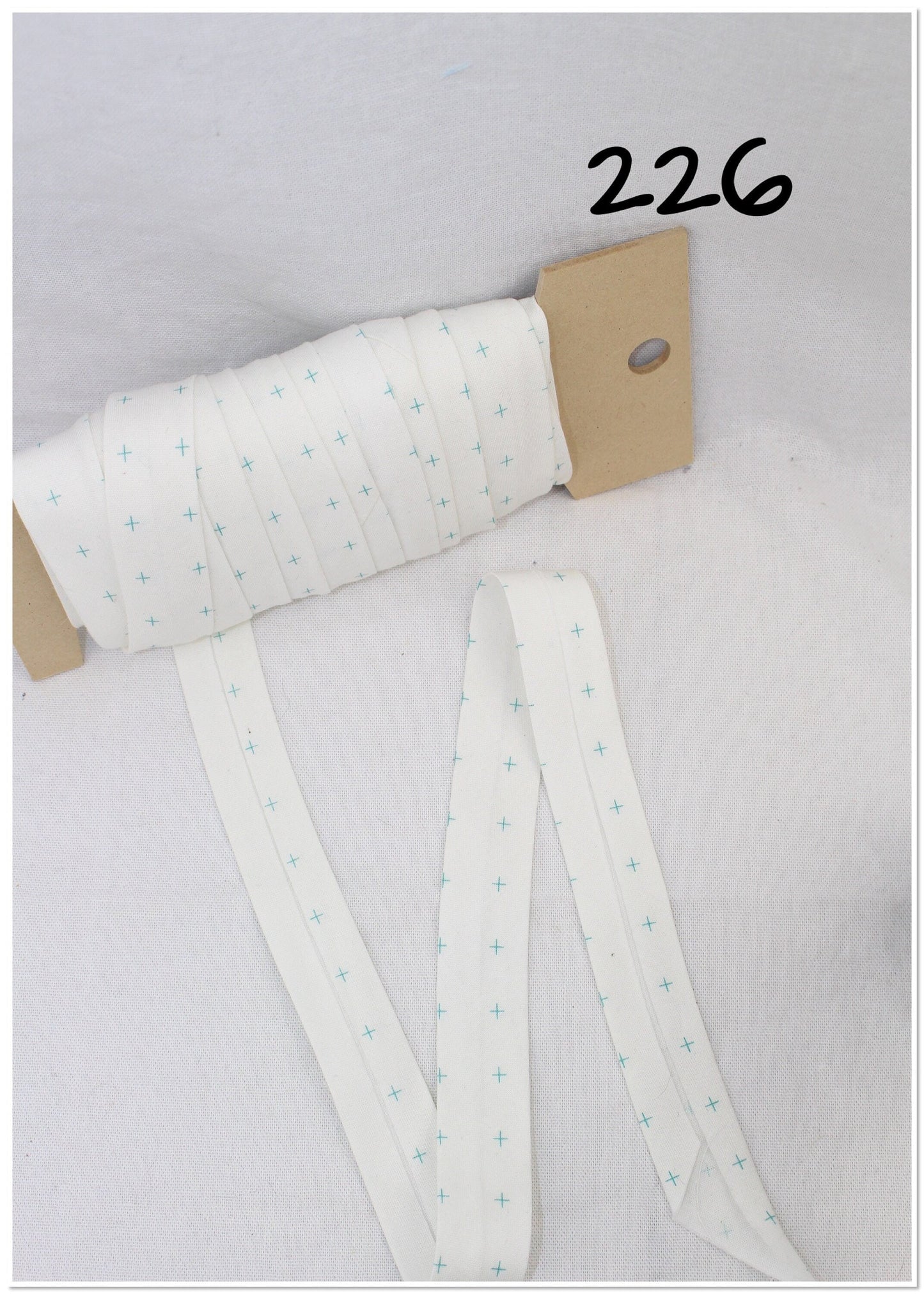 Bias Binding (Tape) 25mm, Cotton, Single Fold, white and crosses. Fusible iron on available.