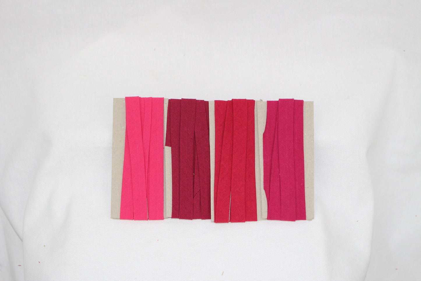 Bias Binding (tape) 25mm, single fold. Cerise, bright rose, rumba red, crimson. Fusible iron on available. 100% Cotton